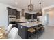 Modern kitchen featuring dark cabinets, stainless steel appliances, a spacious island, and stylish pendant lighting at 9230 E Cloudview Ave, Gold Canyon, AZ 85118