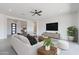 Bright and airy living room featuring a ceiling fan, contemporary furnishings, and stylish decor at 9230 E Cloudview Ave, Gold Canyon, AZ 85118