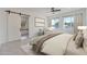 Serene main bedroom featuring a cozy seating area, natural light, and an ensuite bathroom with a barn door at 9230 E Cloudview Ave, Gold Canyon, AZ 85118