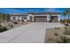 Stunning home featuring desert landscaping, neutral colors, and a wide driveway leading to a two-car garage at 9278 E Cloudview Ave, Gold Canyon, AZ 85118