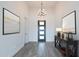 Modern foyer with neutral colors, tiled floors, and a stylish chandelier at 9278 E Cloudview Ave, Gold Canyon, AZ 85118