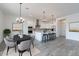 Open-concept kitchen with white cabinets, a large island with seating, and a connected dining area at 9278 E Cloudview Ave, Gold Canyon, AZ 85118