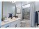 Modern bathroom featuring a white vanity with a quartz countertop, black hardware, and a tiled shower-tub combo at 9398 E Cloudview Ave, Gold Canyon, AZ 85118