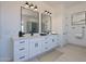 Bright bathroom featuring dual sinks, quartz countertops, and modern fixtures at 9398 E Cloudview Ave, Gold Canyon, AZ 85118