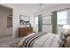 Comfortable bedroom showcasing neutral decor, stylish dresser, and soft natural light, creating a relaxing ambiance at 9398 E Cloudview Ave, Gold Canyon, AZ 85118