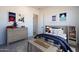 Bright ' bedroom featuring a stylish gray wood dresser and matching bed frame with cheerful art and decor at 9398 E Cloudview Ave, Gold Canyon, AZ 85118