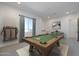 Spacious game room with a classic pool table, cue rack, and a serene window view, perfect for entertaining at 9398 E Cloudview Ave, Gold Canyon, AZ 85118