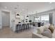 Modern kitchen and dining area with stainless appliances, island seating, and lots of natural light at 9398 E Cloudview Ave, Gold Canyon, AZ 85118