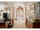 This luxury bathroom boasts dual vanities with intricate columns and mirrors and a soaking tub at 9547 N 55Th St, Paradise Valley, AZ 85253