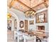 Dining room with a brick ceiling, fireplace, decorative lighting, and beautiful wood table at 9547 N 55Th St, Paradise Valley, AZ 85253