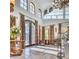 Sun-drenched foyer with a stone entryway, high ceilings, arched windows, and tiled floors at 9547 N 55Th St, Paradise Valley, AZ 85253