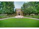 Front exterior view featuring a stone facade, fountain, manicured landscaping, and mature trees at 9547 N 55Th St, Paradise Valley, AZ 85253