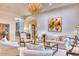 Elegant living room with a crystal chandelier, white sofas, and an arched doorway at 9547 N 55Th St, Paradise Valley, AZ 85253