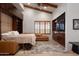 Living room with a pull-down bed, vaulted ceiling, ceiling fan, and custom wood cabinetry at 9547 N 55Th St, Paradise Valley, AZ 85253