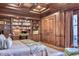 Luxurious main bedroom with hardwood floors, custom bookshelves, and a coffered ceiling at 9547 N 55Th St, Paradise Valley, AZ 85253