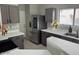 A modern kitchen has sleek countertops, stainless steel appliances, and ample cabinet space at 9621 N 82Nd Ln, Peoria, AZ 85345