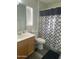 Cozy bathroom features a vanity, toilet, and shower with a stylish curtain at 11821 W Yuma St, Avondale, AZ 85323