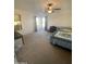 Carpeted main bedroom with ceiling fan and natural light from two windows at 11821 W Yuma St, Avondale, AZ 85323