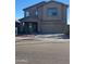 Two-story home featuring a covered porch, an attached two-car garage, and a combination of stucco and siding at 11821 W Yuma St, Avondale, AZ 85323