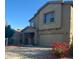 Two-story home featuring a covered porch, an attached two-car garage, and a combination of stucco and siding at 11821 W Yuma St, Avondale, AZ 85323