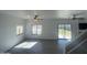 Bright living room featuring wood-look tile flooring, windows, and sliding glass doors at 11821 W Yuma St, Avondale, AZ 85323