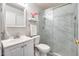 Bright bathroom featuring a glass door shower, modern fixtures, and ample storage space at 12766 W Dreyfus Dr, El Mirage, AZ 85335