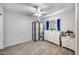 Well-lit bedroom with wood-look floors, decorative screen, and dresser with mirror at 12766 W Dreyfus Dr, El Mirage, AZ 85335