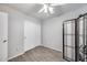 Bedroom with wood-look floors, white sliding closet doors, and decorative screen at 12766 W Dreyfus Dr, El Mirage, AZ 85335