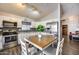 Updated kitchen featuring white cabinetry, stainless steel appliances, and a breakfast nook at 12766 W Dreyfus Dr, El Mirage, AZ 85335