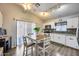 Eat-in kitchen featuring modern appliances, hardwood floors, and lots of natural light at 12766 W Dreyfus Dr, El Mirage, AZ 85335