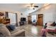 Bright living room featuring vaulted ceilings, a ceiling fan, hardwood floors, and lots of natural light at 12766 W Dreyfus Dr, El Mirage, AZ 85335