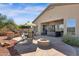 Back patio featuring an outdoor kitchen, spa, desert plants, and covered seating area at 13121 S 178Th Ave, Goodyear, AZ 85338