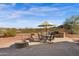 Outdoor patio area with stone flooring, dining table, BBQ, and fire pit, perfect for entertaining at 13121 S 178Th Ave, Goodyear, AZ 85338