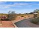 Outdoor living space with fire pit, bbq, and beautiful desert landscaping at 13121 S 178Th Ave, Goodyear, AZ 85338