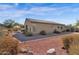 Backyard view showcasing the desert landscaping, patio, and exterior of the home at 13121 S 178Th Ave, Goodyear, AZ 85338