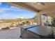 Outdoor living space with covered patio, hot tub, seating area, and built-in grill at 13121 S 178Th Ave, Goodyear, AZ 85338