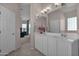 Bathroom featuring double sinks, tile floors, and large mirror at 13121 S 178Th Ave, Goodyear, AZ 85338