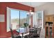 Dining area featuring an accent wall, sliding glass door, and bright natural light at 13121 S 178Th Ave, Goodyear, AZ 85338