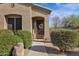 A charming home entrance with a decorative door, a wreath, and well-maintained landscaping at 13121 S 178Th Ave, Goodyear, AZ 85338