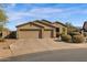 Charming single-story home featuring a three-car garage, desert landscaping, and a tile roof at 13121 S 178Th Ave, Goodyear, AZ 85338