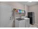 Well-equipped laundry room with newer washer and dryer and ample storage space at 13121 S 178Th Ave, Goodyear, AZ 85338