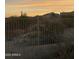 Sunset view looking over the desert landscape featuring cactus and mountains at 13121 S 178Th Ave, Goodyear, AZ 85338