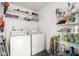 Bright laundry room featuring white washer and dryer, overhead storage shelf, and wire rack at 13204 N 3Rd Way, Phoenix, AZ 85022