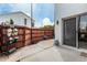 Enclosed patio with privacy fence, potted plants, blue stool, and sliding glass door at 13204 N 3Rd Way, Phoenix, AZ 85022