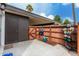 Enclosed patio featuring storage shed, gate, privacy fence and potted flowers on a decorative plant stand at 13204 N 3Rd Way, Phoenix, AZ 85022