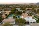 Sprawling estate featuring a pool, tennis court, and lush landscaping, offering a private and luxurious retreat at 13670 N 85Th Pl, Scottsdale, AZ 85260