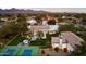 Stunning aerial view of the property, featuring a pool, tennis court, and lush landscaping at 13670 N 85Th Pl, Scottsdale, AZ 85260