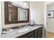 Bathroom featuring granite countertops, dark wood cabinetry, and updated fixtures at 13670 N 85Th Pl, Scottsdale, AZ 85260