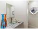 Stylish powder room with unique glass bowl sink, grey granite countertop and decorative accents at 13670 N 85Th Pl, Scottsdale, AZ 85260