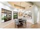 Bright dining area with a view to the backyard and a modern chandelier at 13670 N 85Th Pl, Scottsdale, AZ 85260